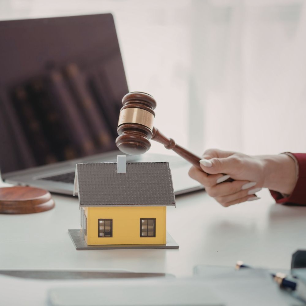 Residential real estate closing attorney in Buffalo, NY with gavel over house model during property closing review