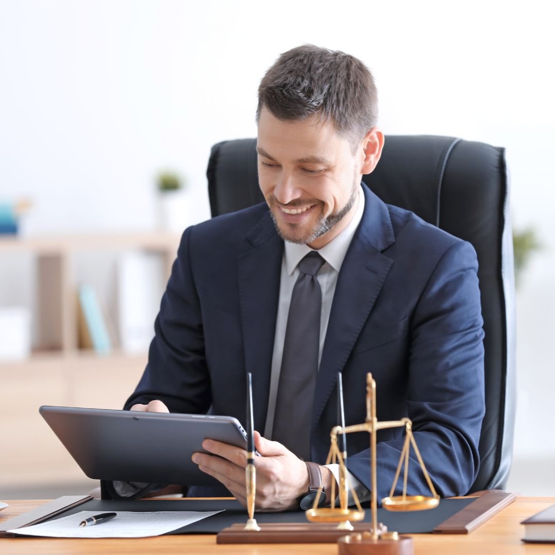 Real estate closing lawyer in Syracuse, NY reviewing documents at his office desk